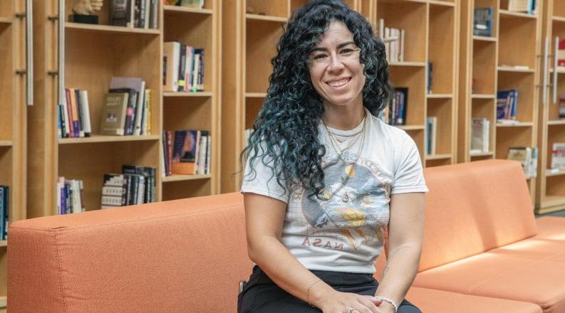 a woman sits on a couch